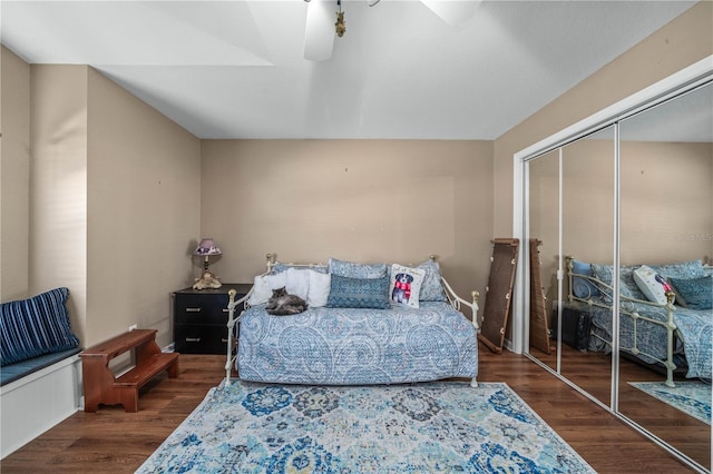 bedroom with ceiling fan, a closet, and dark hardwood / wood-style floors