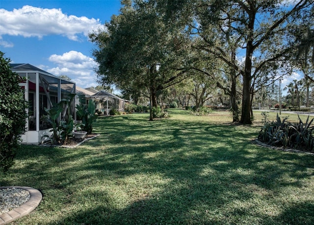 view of yard featuring glass enclosure