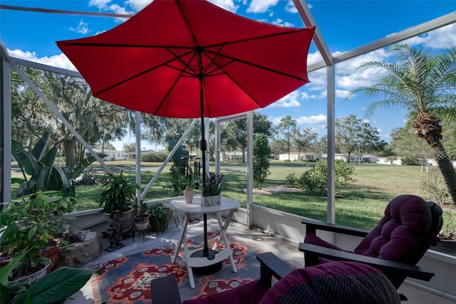 view of patio featuring glass enclosure