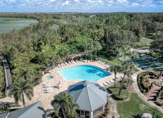 view of pool featuring a water view and a patio