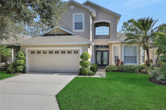 view of front of property featuring french doors, a front yard, and a garage