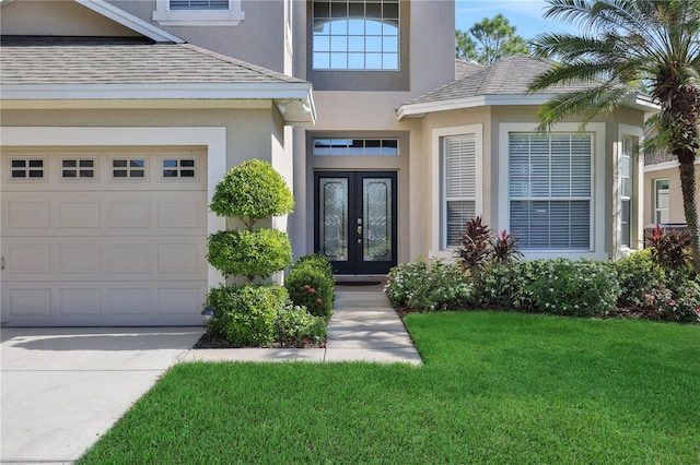 entrance to property with a lawn and french doors