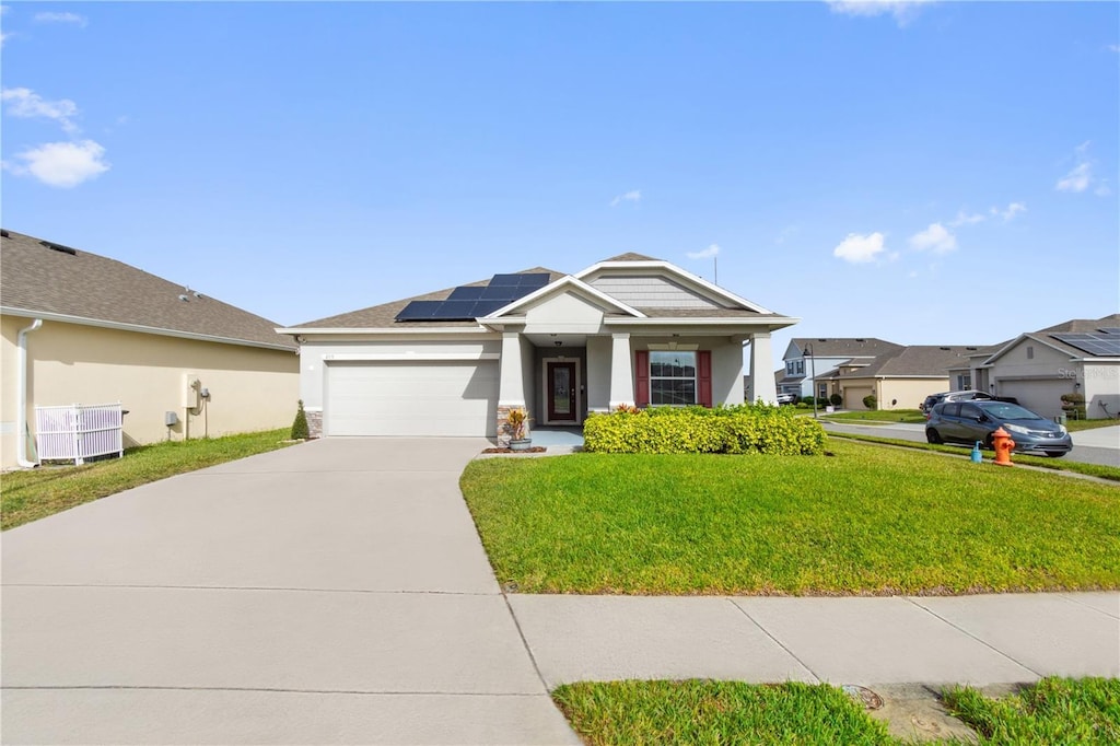 view of front of property with a front lawn, a garage, central AC unit, and solar panels