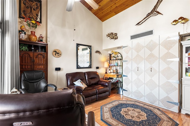 living room with ceiling fan, high vaulted ceiling, tile walls, wooden ceiling, and light hardwood / wood-style floors