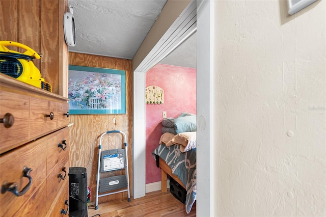 interior space featuring hardwood / wood-style floors and wooden walls