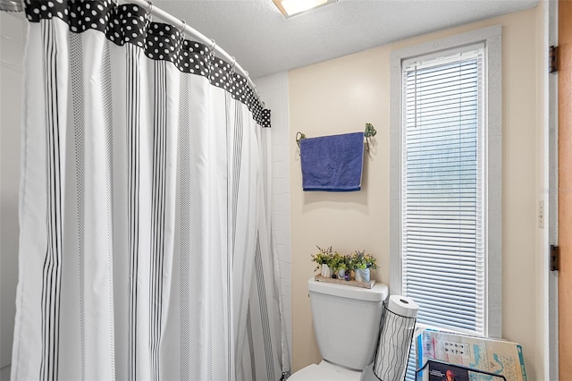 bathroom with a textured ceiling and toilet