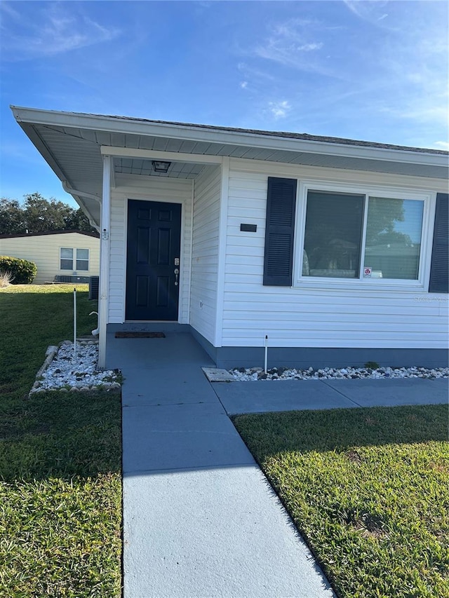 doorway to property featuring a yard