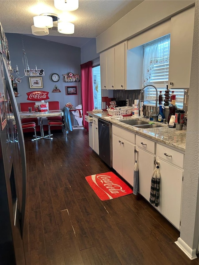 kitchen featuring sink, stainless steel appliances, dark hardwood / wood-style flooring, a textured ceiling, and white cabinets