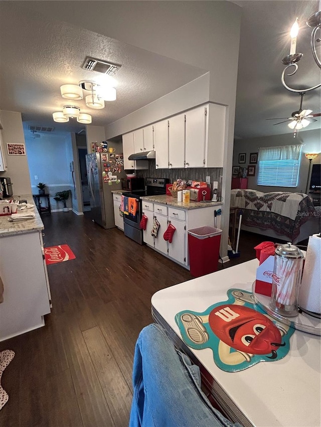 kitchen featuring ceiling fan, stainless steel appliances, dark hardwood / wood-style flooring, decorative backsplash, and white cabinets