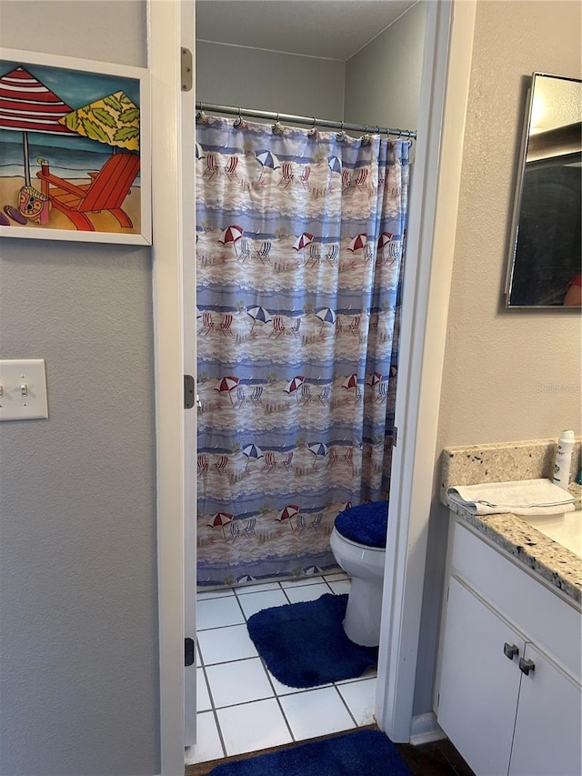 bathroom with tile patterned flooring, vanity, toilet, and a shower with shower curtain