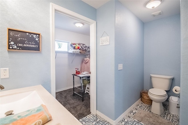 bathroom with tile patterned floors and toilet