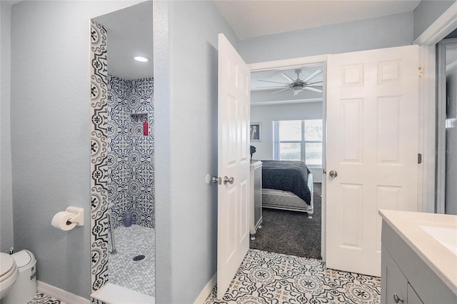 bathroom featuring a shower, vanity, toilet, and ceiling fan