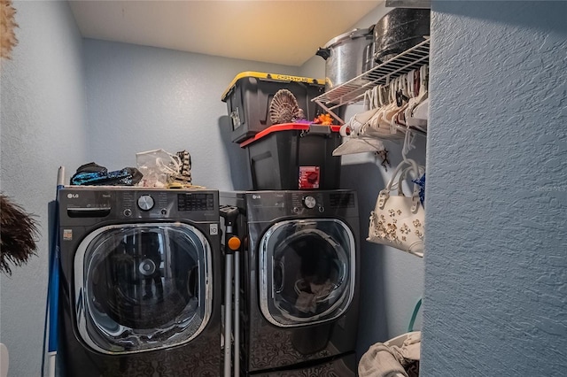 clothes washing area with washer and dryer