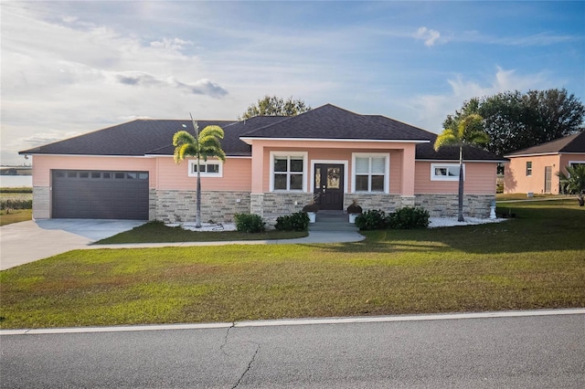 view of front facade with a garage and a front lawn