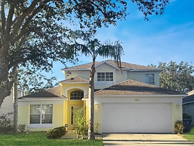 view of front of house with a garage and a front yard