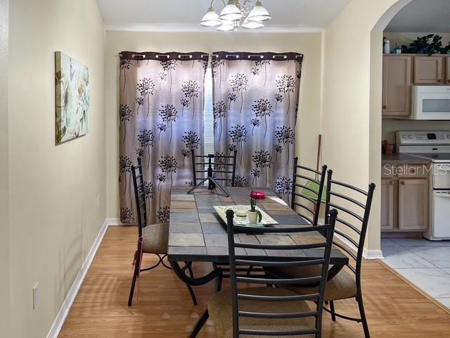 dining space featuring light hardwood / wood-style floors and a notable chandelier