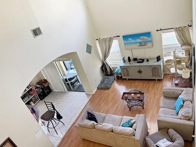 living room featuring light hardwood / wood-style floors and a high ceiling