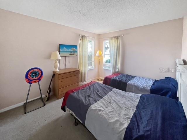 bedroom featuring carpet flooring and a textured ceiling