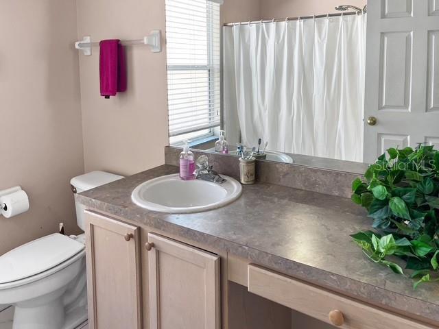 bathroom featuring vanity and toilet