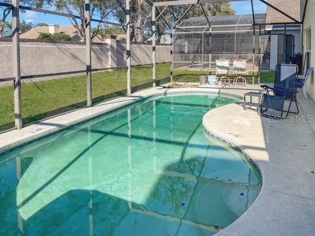 view of swimming pool with a lawn and a patio area