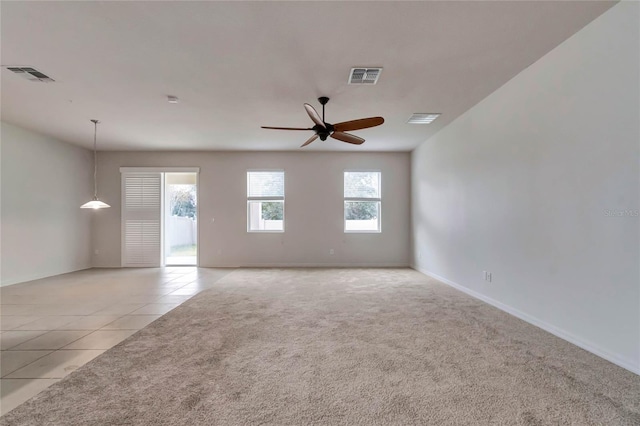 tiled empty room featuring ceiling fan