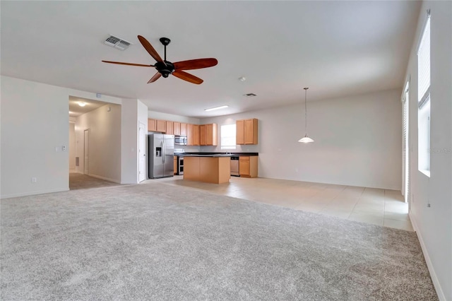 unfurnished living room featuring ceiling fan and light colored carpet