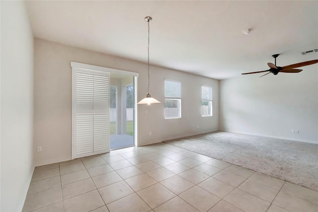 tiled empty room featuring ceiling fan