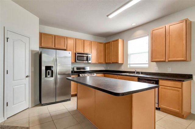 kitchen featuring a kitchen island, stainless steel appliances, and light tile patterned floors