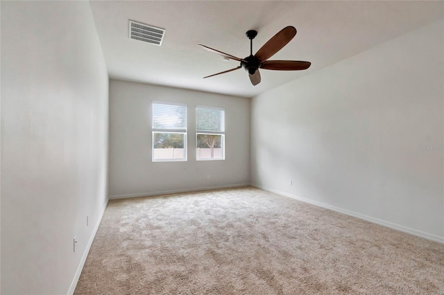 spare room featuring ceiling fan and light colored carpet