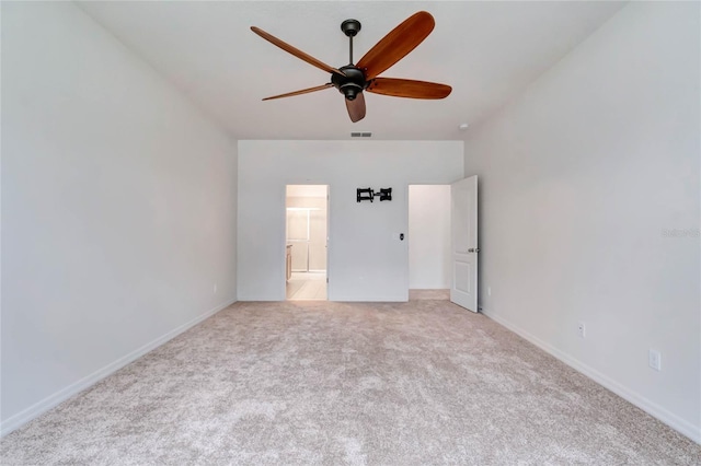 empty room featuring ceiling fan and light colored carpet