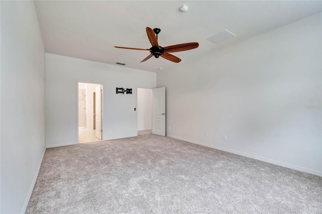 unfurnished bedroom with ensuite bathroom, ceiling fan, and light colored carpet