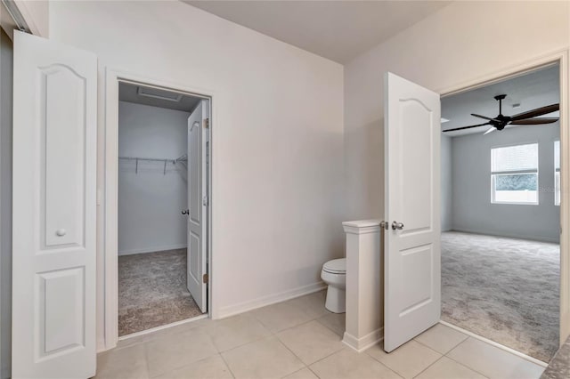 bathroom with tile patterned floors, ceiling fan, and toilet