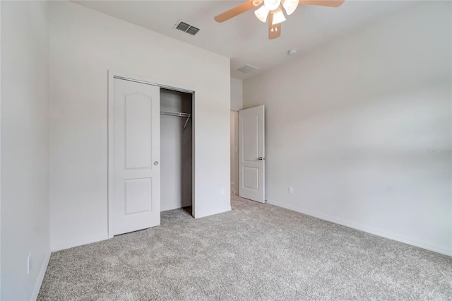 unfurnished bedroom with ceiling fan, a closet, and light carpet