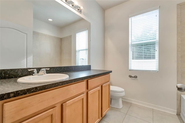 bathroom with vanity, plenty of natural light, tile patterned flooring, and toilet