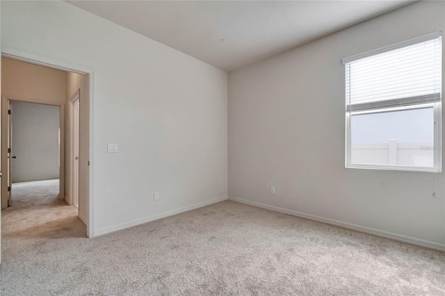 unfurnished room with light carpet and a wealth of natural light