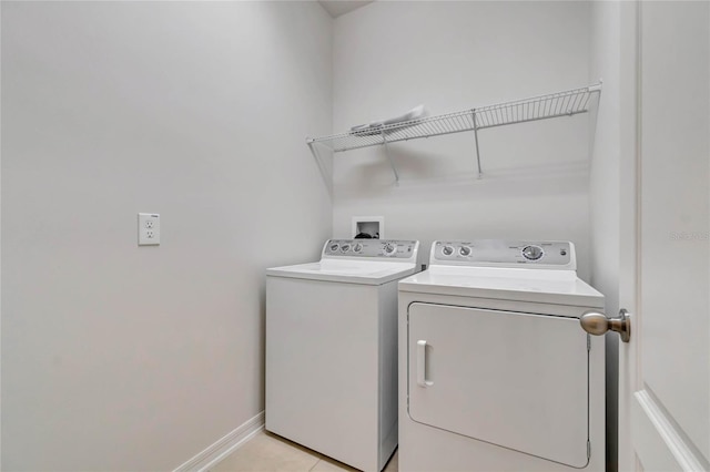 laundry room featuring light tile patterned floors and washing machine and clothes dryer