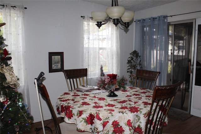 dining area featuring hardwood / wood-style flooring and a chandelier