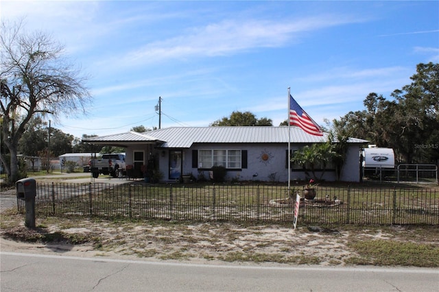 ranch-style house featuring a carport and a front lawn