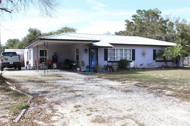 ranch-style home featuring a carport