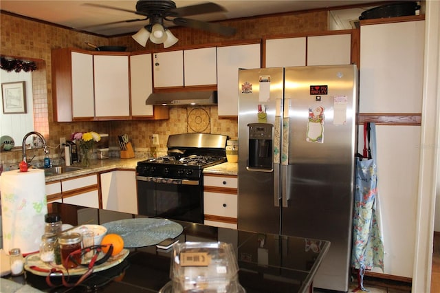 kitchen with sink, ceiling fan, white cabinetry, stainless steel appliances, and tasteful backsplash