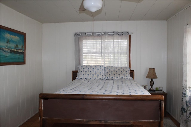 bedroom with wooden walls