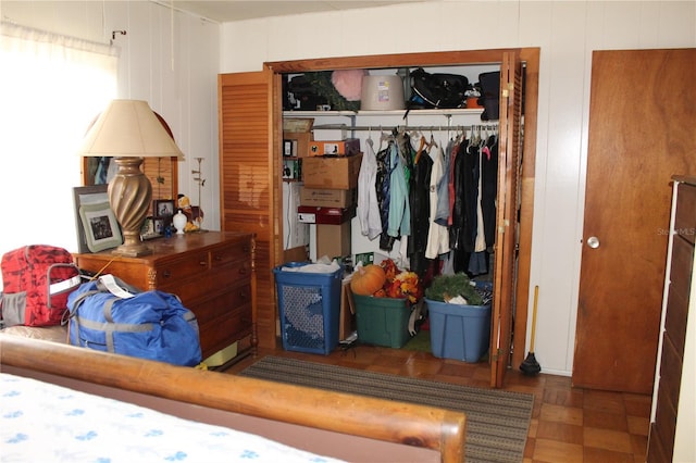 bedroom with parquet flooring and a closet