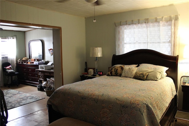 bedroom with wood-type flooring and multiple windows