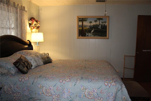 bedroom with wood walls