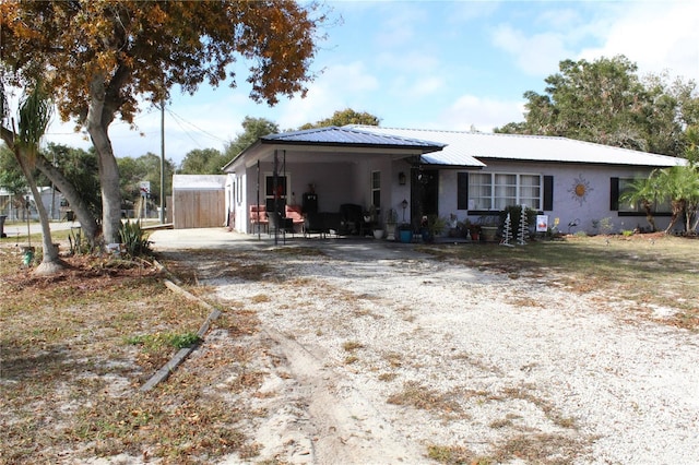 view of front of property featuring a carport