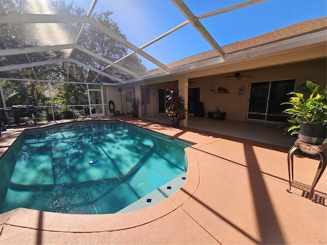 view of pool featuring a lanai, a patio area, and ceiling fan