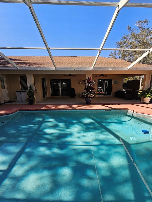 view of pool featuring ceiling fan, a lanai, and a patio