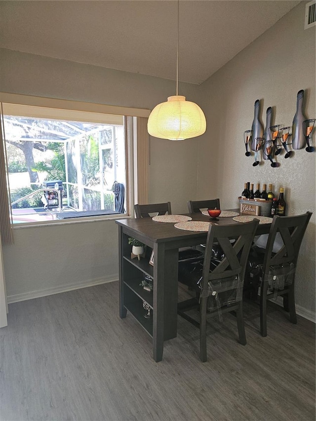 dining space with plenty of natural light and wood-type flooring