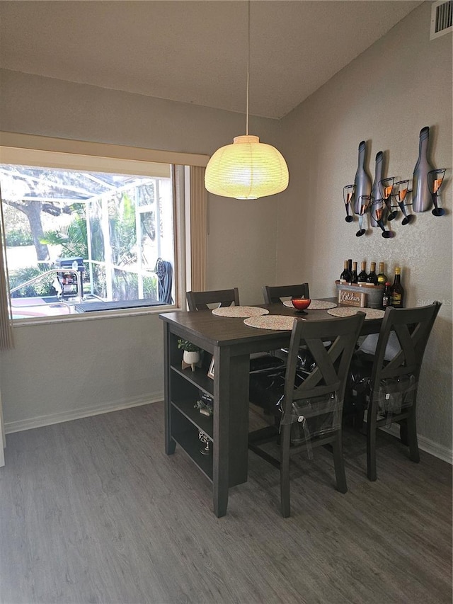 dining area featuring dark wood-type flooring