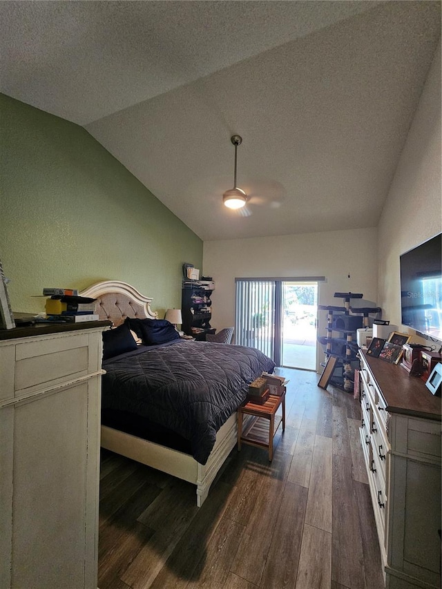 bedroom featuring access to exterior, ceiling fan, dark wood-type flooring, a textured ceiling, and lofted ceiling